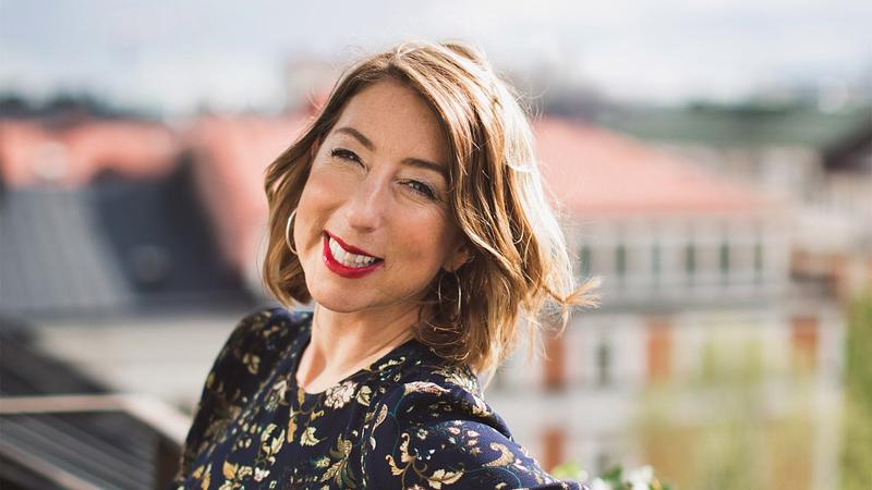 Author Jenny Colgan, white woman with a short brown bob, smiles into the camera